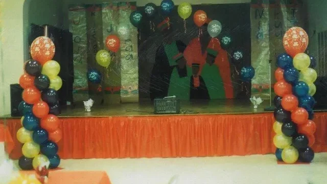 red, blue, and yellow balloon arch and columns on a stage