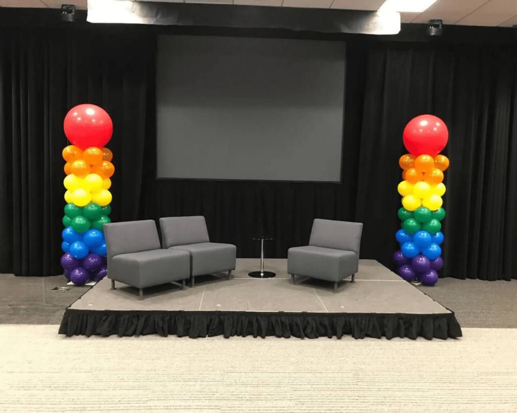two rainbow colored balloon columns