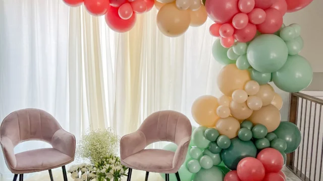 balloon garland with beige, pinks, and green colors