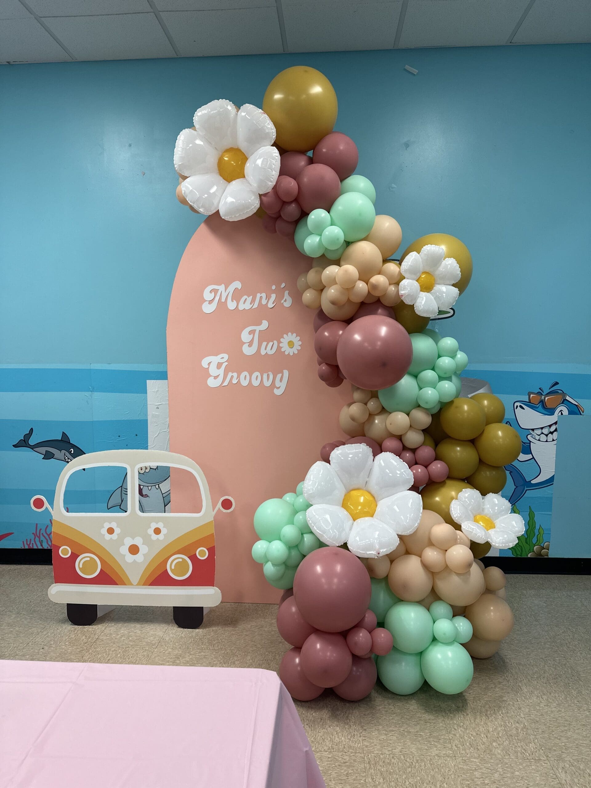 chiara wall arch backdrop with flowers and a van